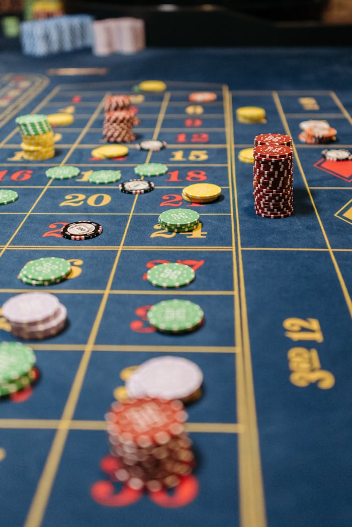 Close-up of a roulette table with stacks of colorful chips during a game.