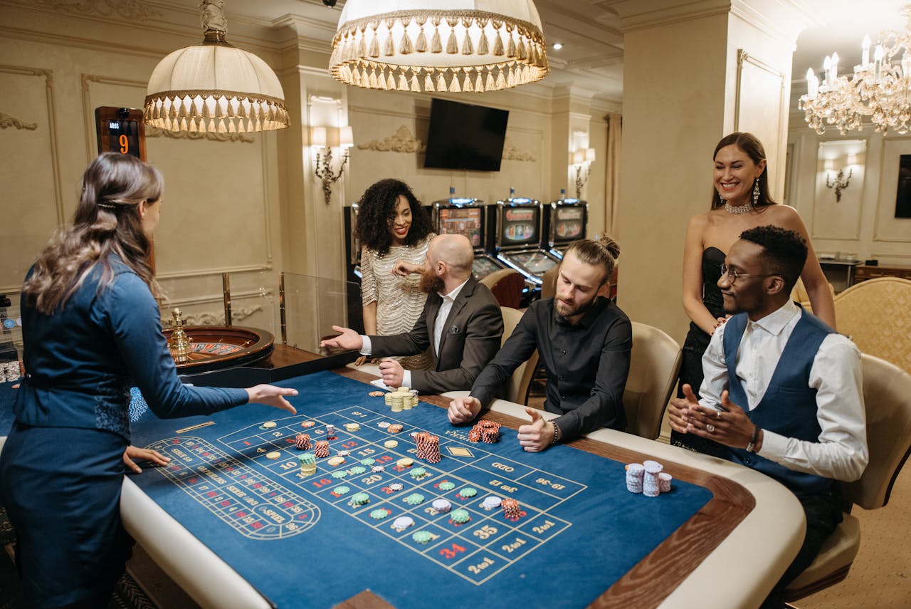 Group of people enjoying a lively night at the casino, playing roulette.